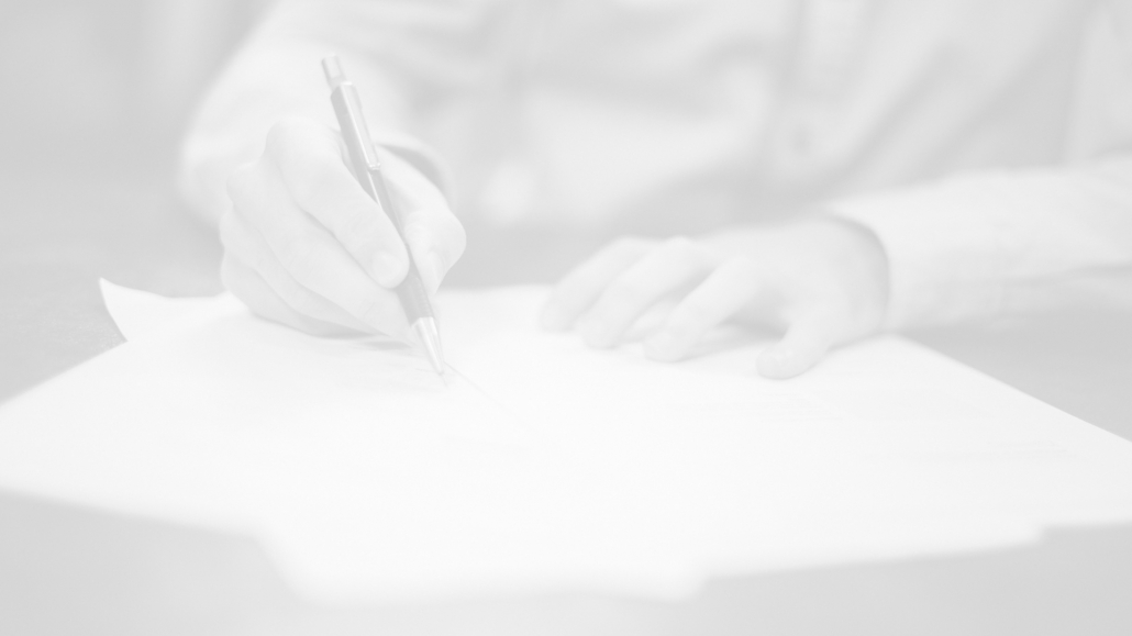 A photograph of a person writing out a report for the life care planning at GSO Health.